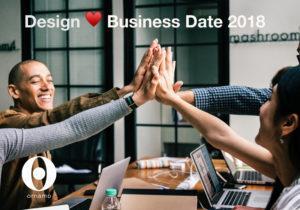 Design sydän Business Date 2018 -kuvituskuva, jossa ihmiset antavat toisilleen läpyt (''high fivet'') työpöydän ääressä.