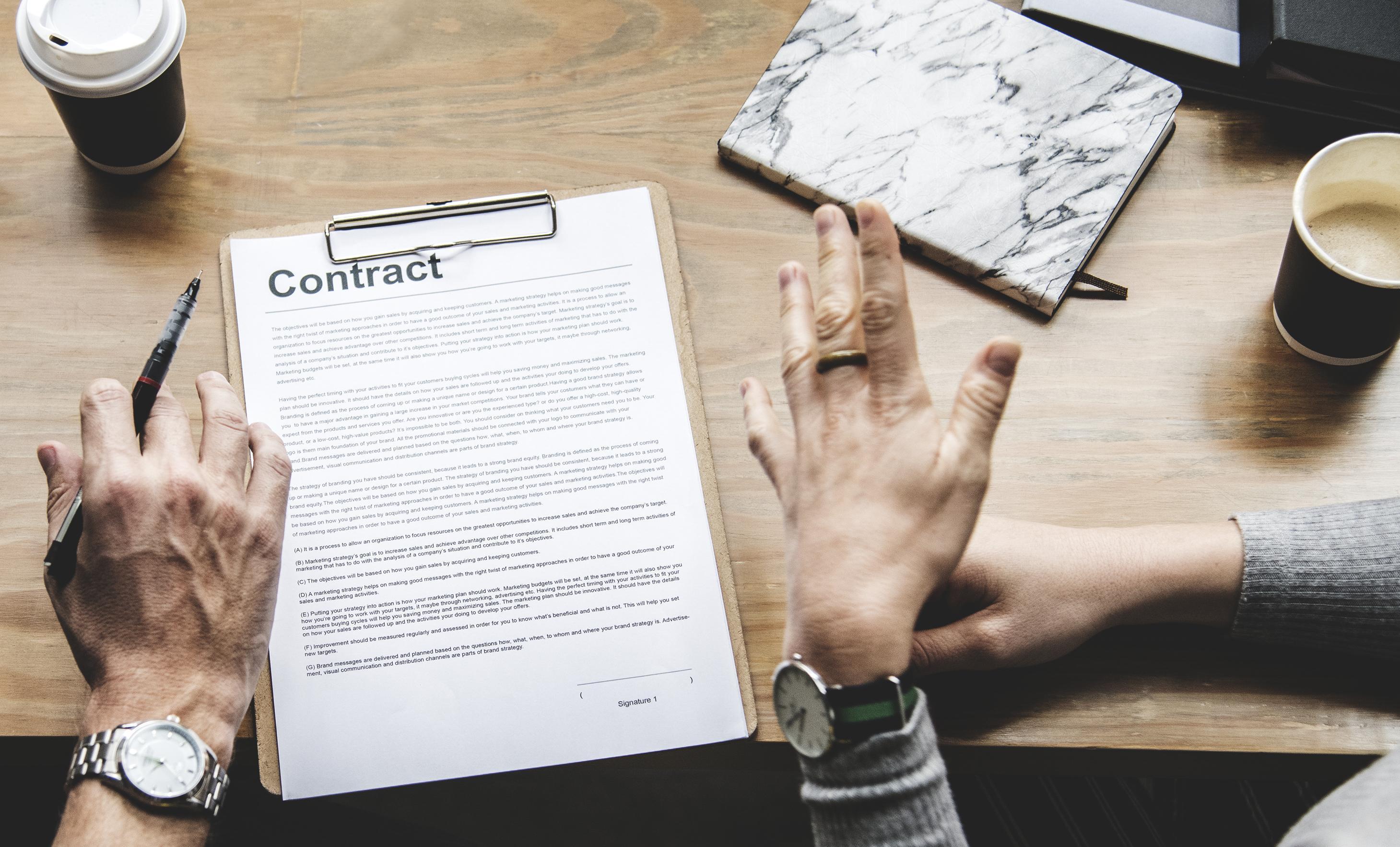 Business people discussing a contract by the table