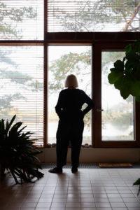 Vuokko Eskolin-Nurmesmiemi katsoo ikkunasta ulos